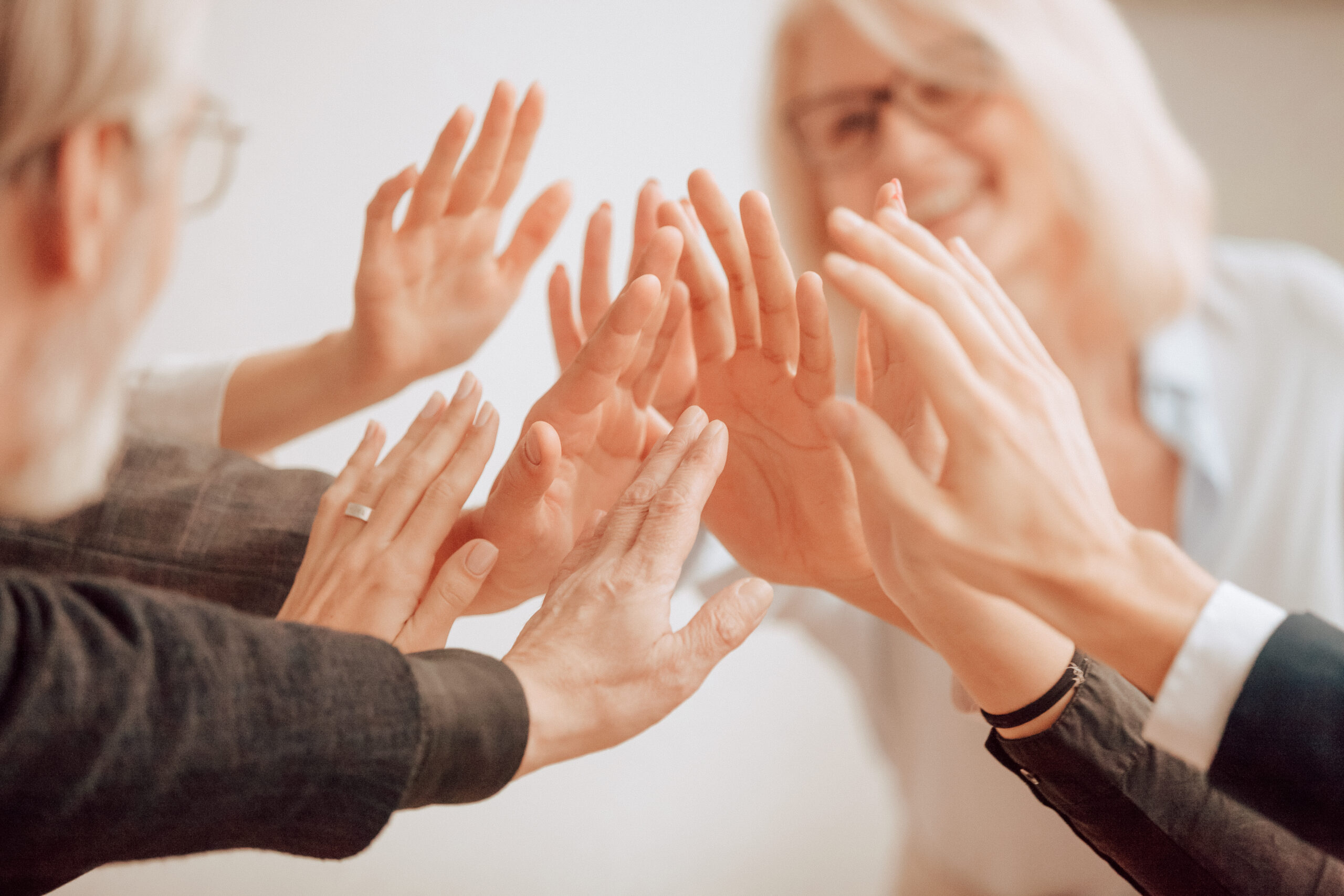 Hands of diverse business people giving high five